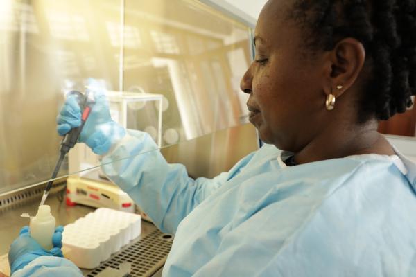 Black women scientist using a pipette in the lab