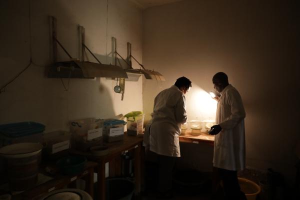 A woman scientist in a dimly lit laboratory