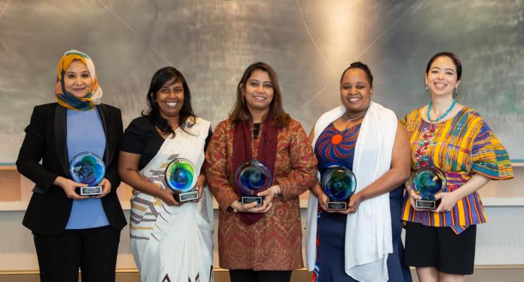Women scientists holding awards