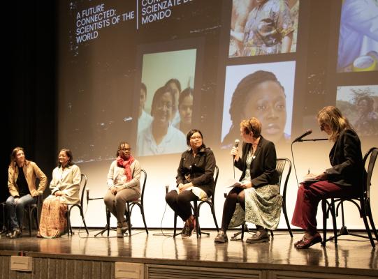 Diverse women on stage taking part in panel discussion
