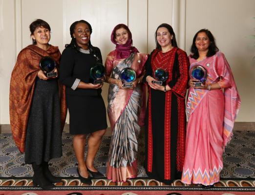 Women scientists holding awards