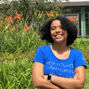 Thara Caba is smiling surrounded by plants.
