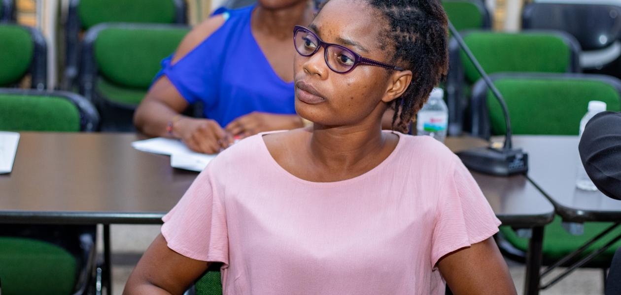 Woman listens to a speaker at a workshop