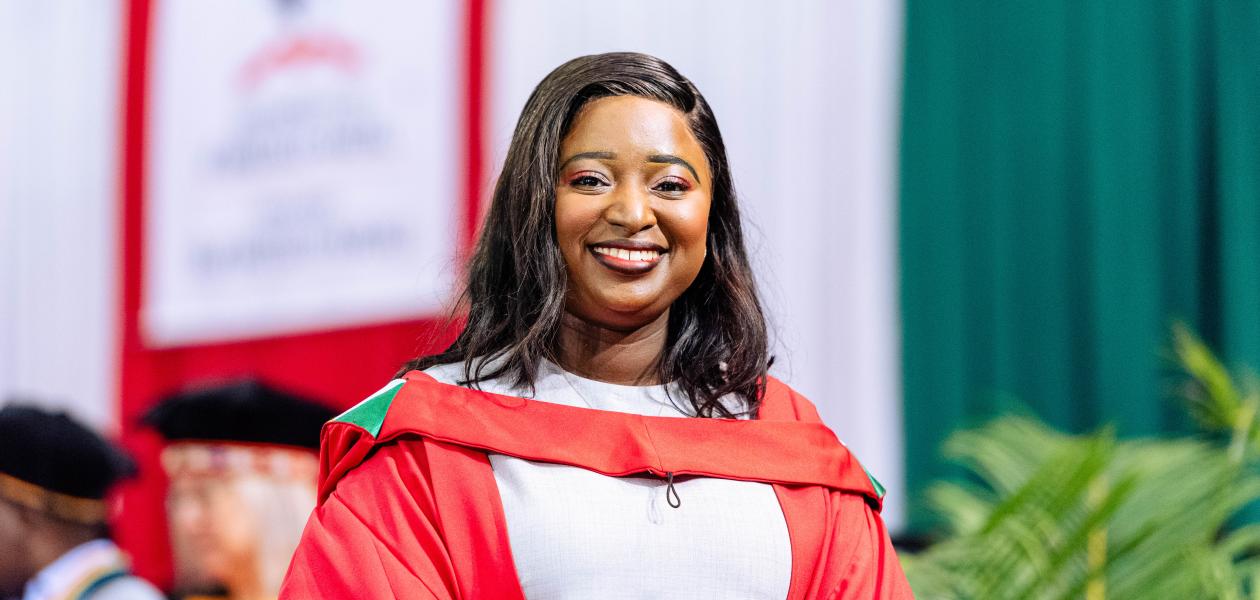 OWSD PhD fellow - black woman wearing doctorate gown