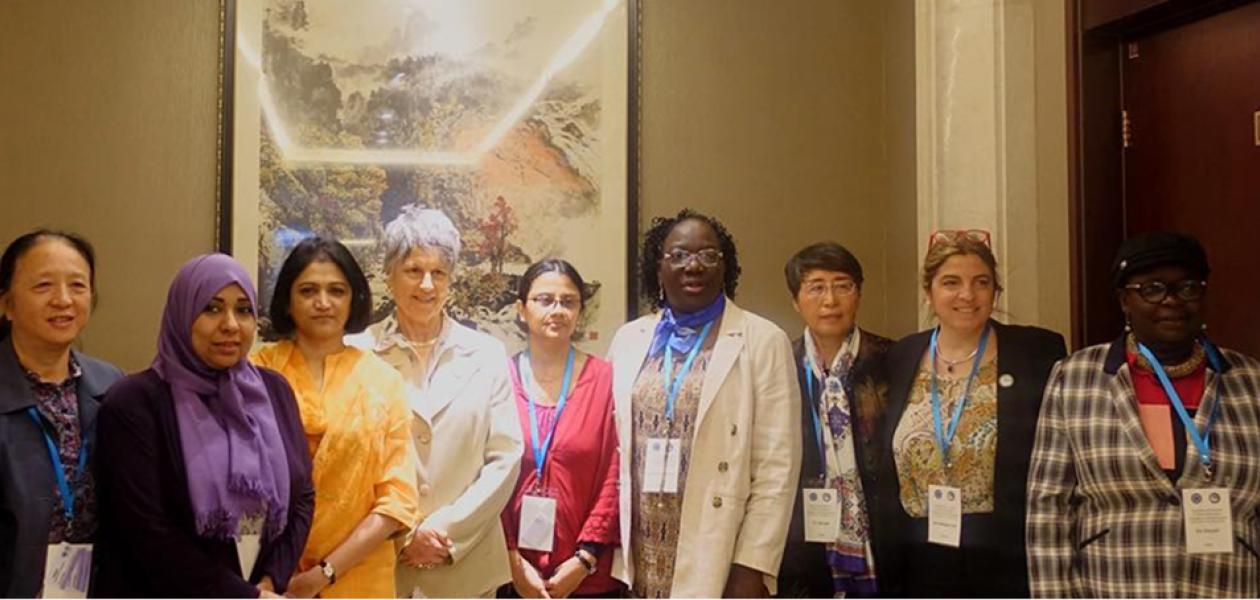 Line of OWSD members, board and Secretariat posing for photo